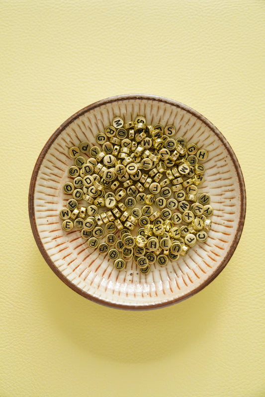 CHARM #106 - round gold letters